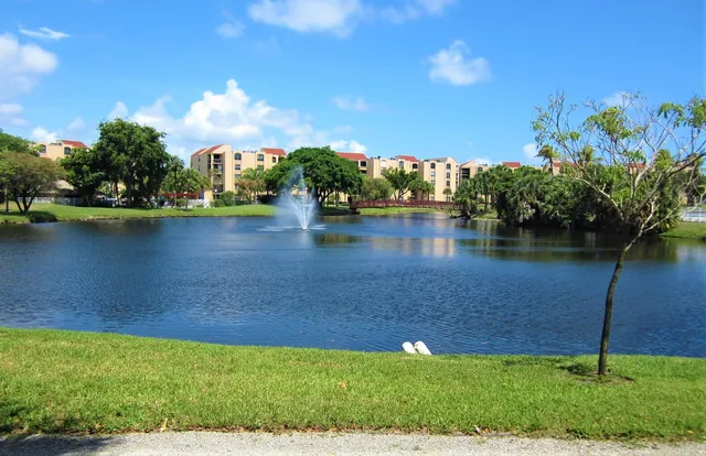 a view of a lake with a house in the background