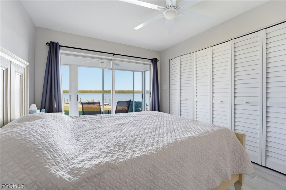 4440 Exeter Drive Longboat Key, FL 34228 - Photo 11 of 24 a large bed sitting in a bedroom next to a window