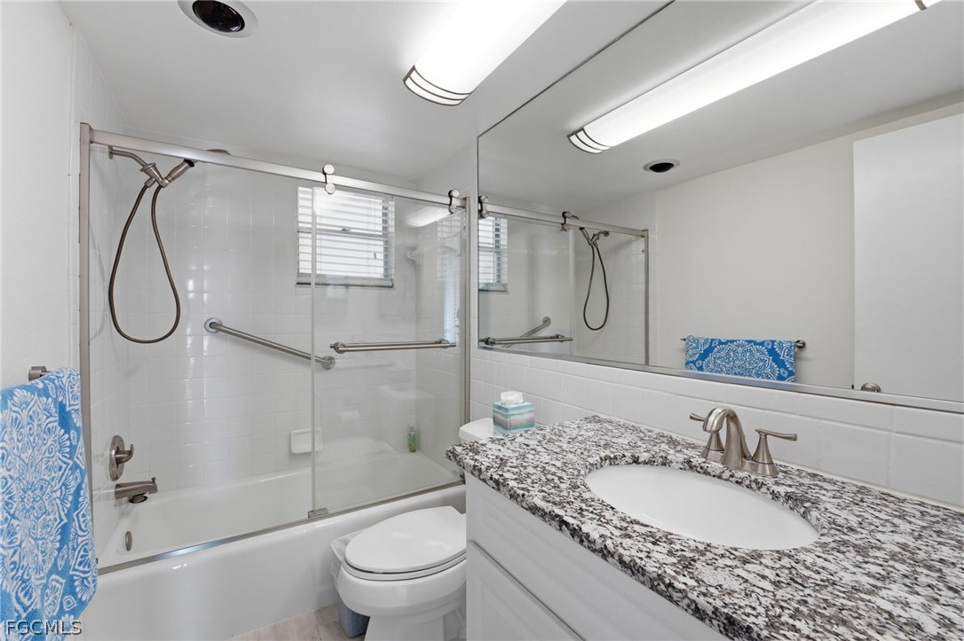 4440 Exeter Drive Longboat Key, FL 34228 - Photo 15 of 24 a bathroom with a granite countertop sink toilet and shower