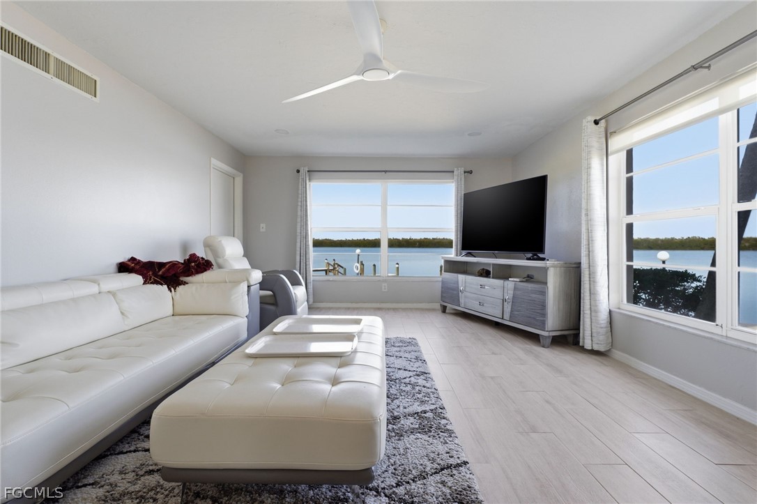 4440 Exeter Drive Longboat Key, FL 34228 - Photo 7 of 24 a living room with furniture and a flat screen tv