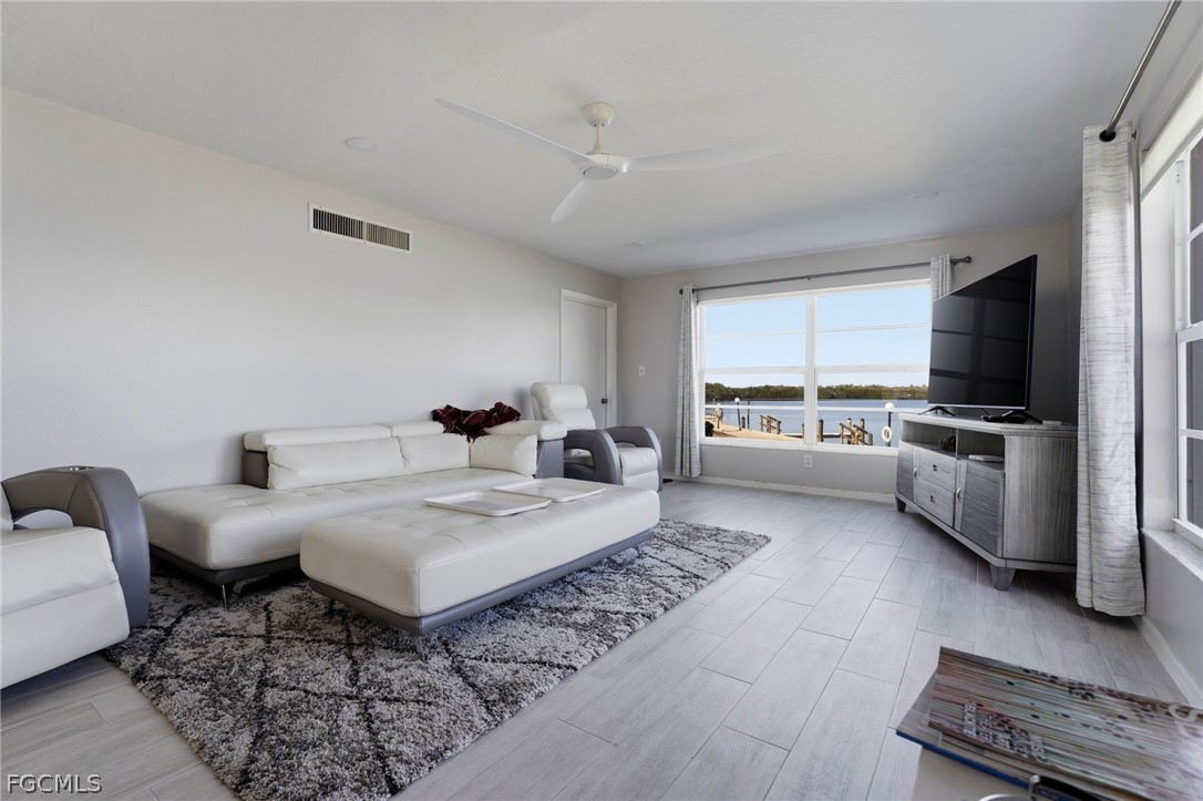 4440 Exeter Drive Longboat Key, FL 34228 - Photo 8 of 24 a living room with furniture and a flat screen tv