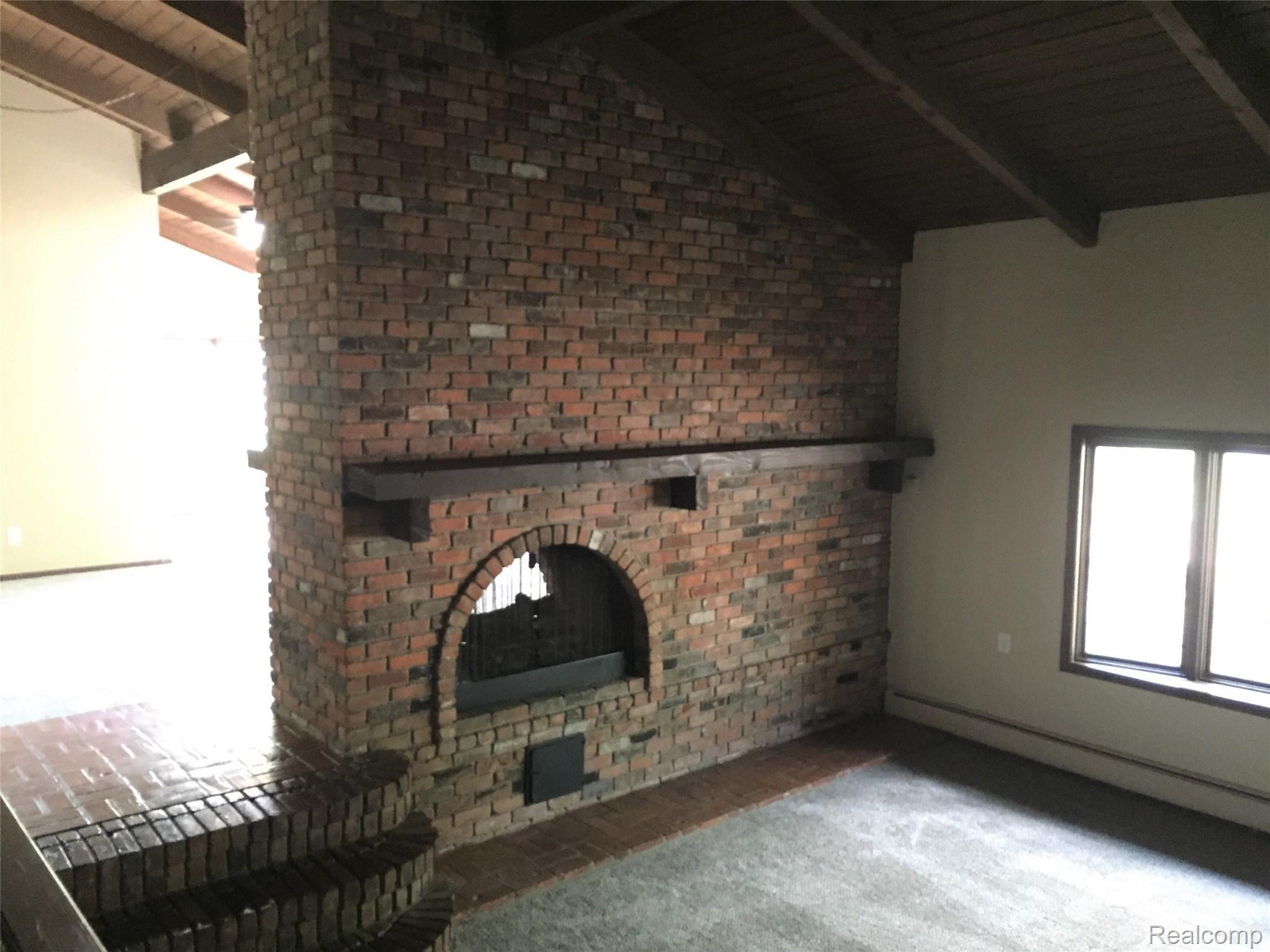 11121 Messmore Road Utica, MI 48317 - Photo 11 of 34 family room view of double sided fireplace.jpg