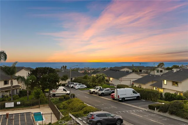 a view of city street with a car parked on the road