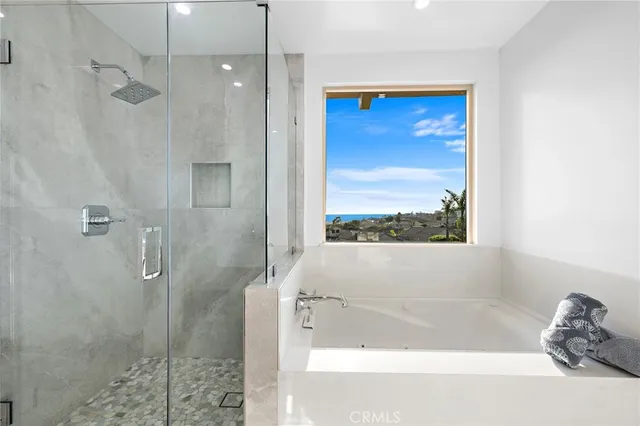 a bathroom with a tub shower and a sink