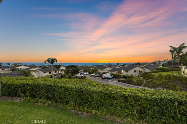 a view of a patio with table and chairs potted plants with wooden floor and fence