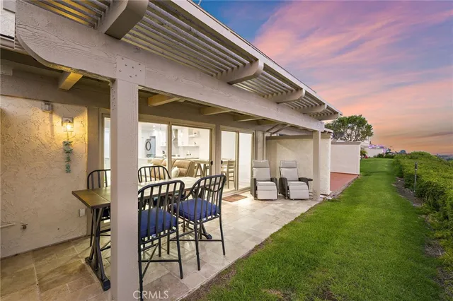 a view of a patio with table and chairs with wooden floor and fence