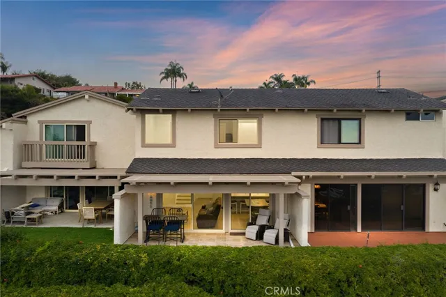 a front view of a house with a garden and trees