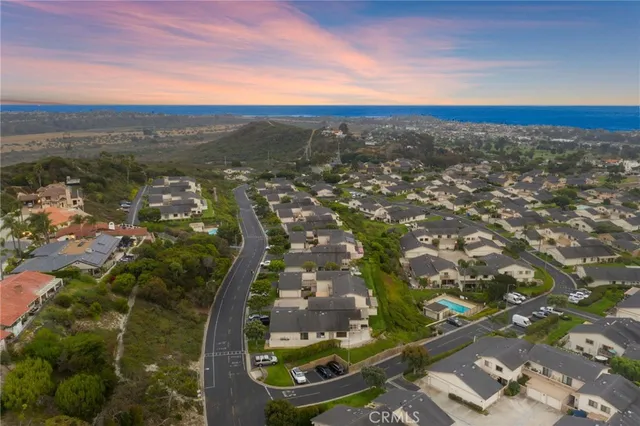 an aerial view of residential houses with city view