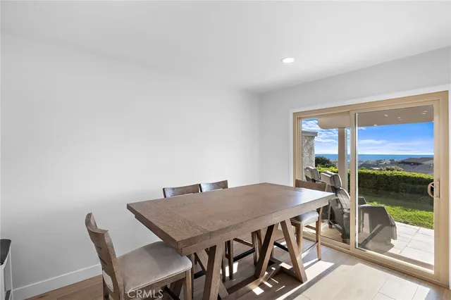 a view of a dining room with furniture wooden floor and next to a window