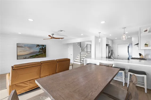 a large kitchen with kitchen island a stove a sink a dining table and chairs