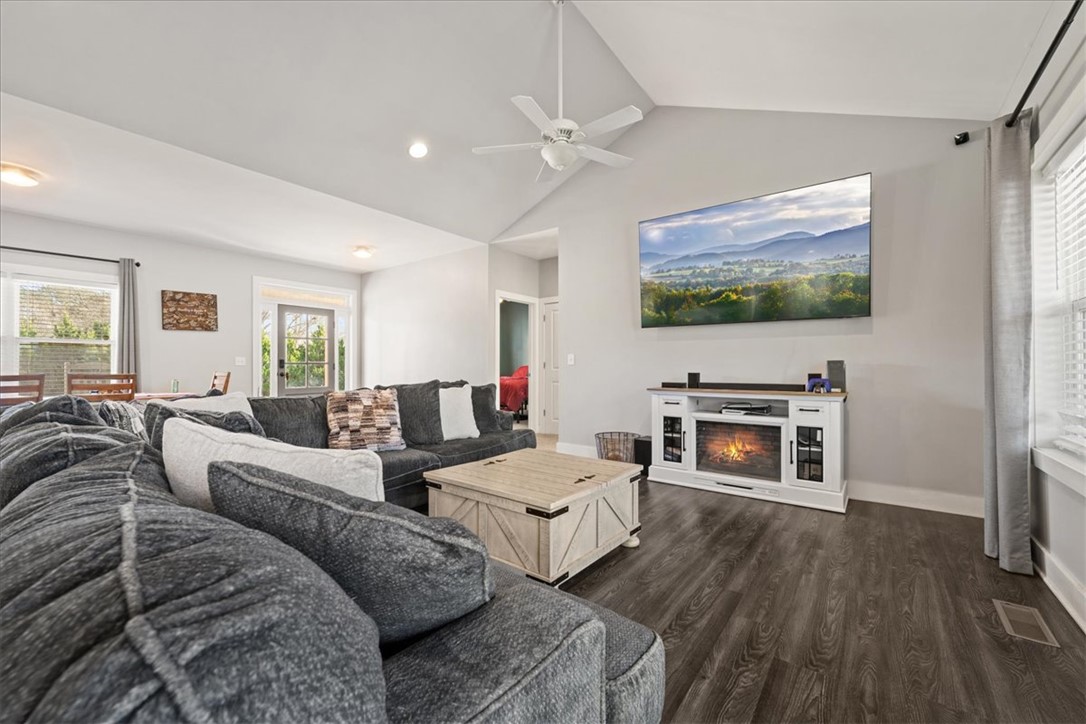 212 Winding Lane Seneca, SC 29672 - Photo 9 of 47 This living room offers comfort and style with vaulted ceilings and durable flooring.