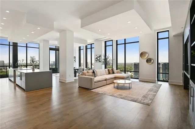 a living room with fireplace furniture and a large window