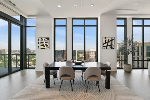 a living room with furniture and a floor to ceiling window