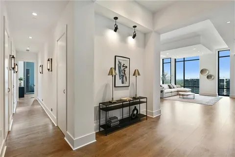 a view of a bedroom with furniture and wooden floor