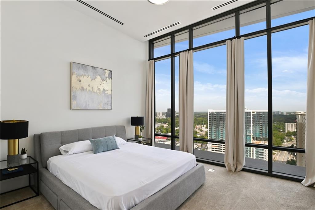 3107 Peachtree Road Northeast, Unit 2003 Atlanta, GA 30305 - Photo 48 of 114 a spacious bedroom with a large window and a balcony