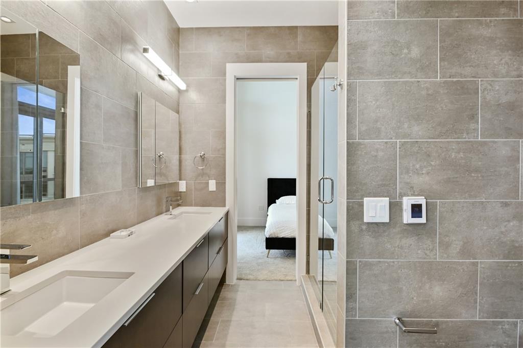 3107 Peachtree Road Northeast, Unit 2003 Atlanta, GA 30305 - Photo 50 of 114 a bathroom with a double vanity sink and mirror