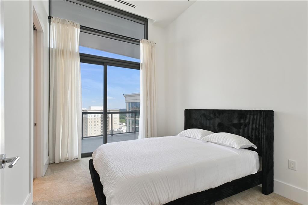 3107 Peachtree Road Northeast, Unit 2003 Atlanta, GA 30305 - Photo 54 of 114 a large bed sitting in a bedroom next to a window