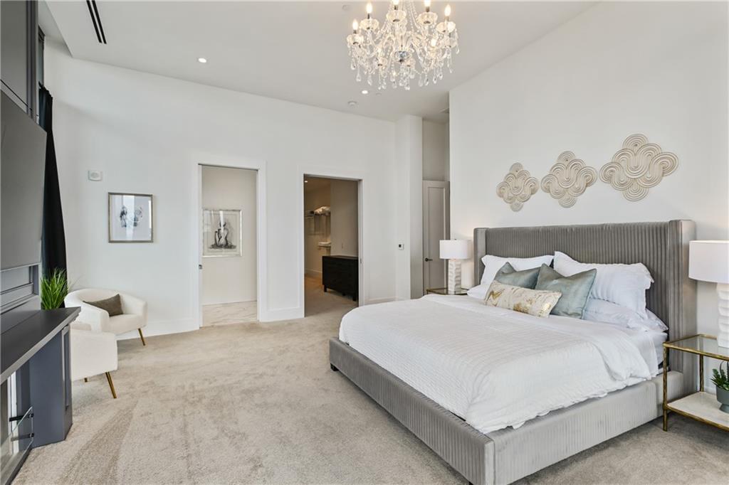 3107 Peachtree Road Northeast, Unit 2003 Atlanta, GA 30305 - Photo 65 of 114 a bedroom with a bed and a chandelier