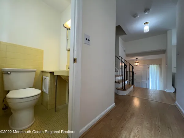 a kitchen with stainless steel appliances kitchen island granite countertop a refrigerator a oven a sink with a dining table and chairs