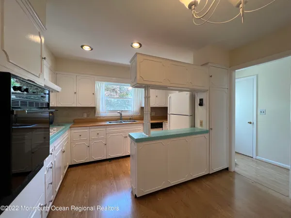 a kitchen with stainless steel appliances a sink and a refrigerator