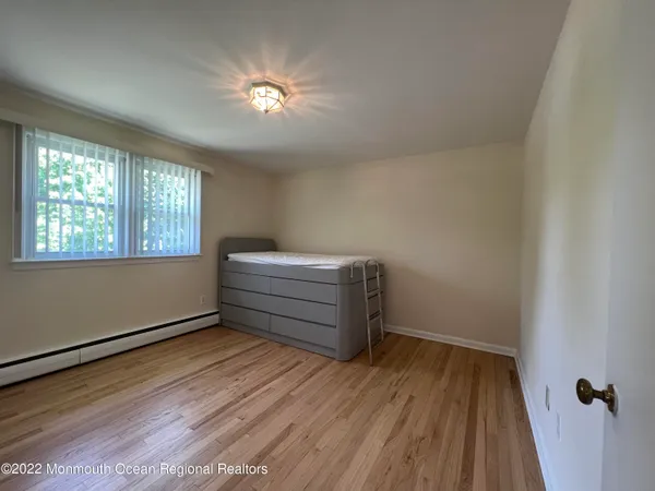 a room with a hardwood and ceiling fan