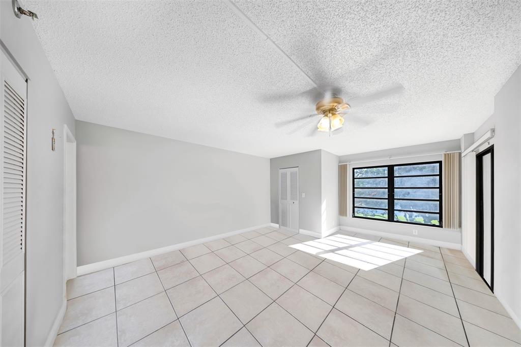 2202 South Cypress Bend Drive, Unit 207 Pompano Beach, FL 33069 - Photo 16 of 20 a view of an empty room with a window