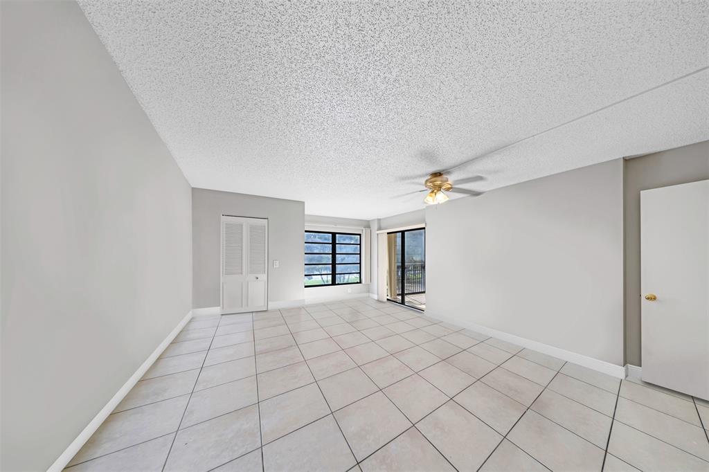 2202 South Cypress Bend Drive, Unit 207 Pompano Beach, FL 33069 - Photo 17 of 20 a view of an empty room with a window