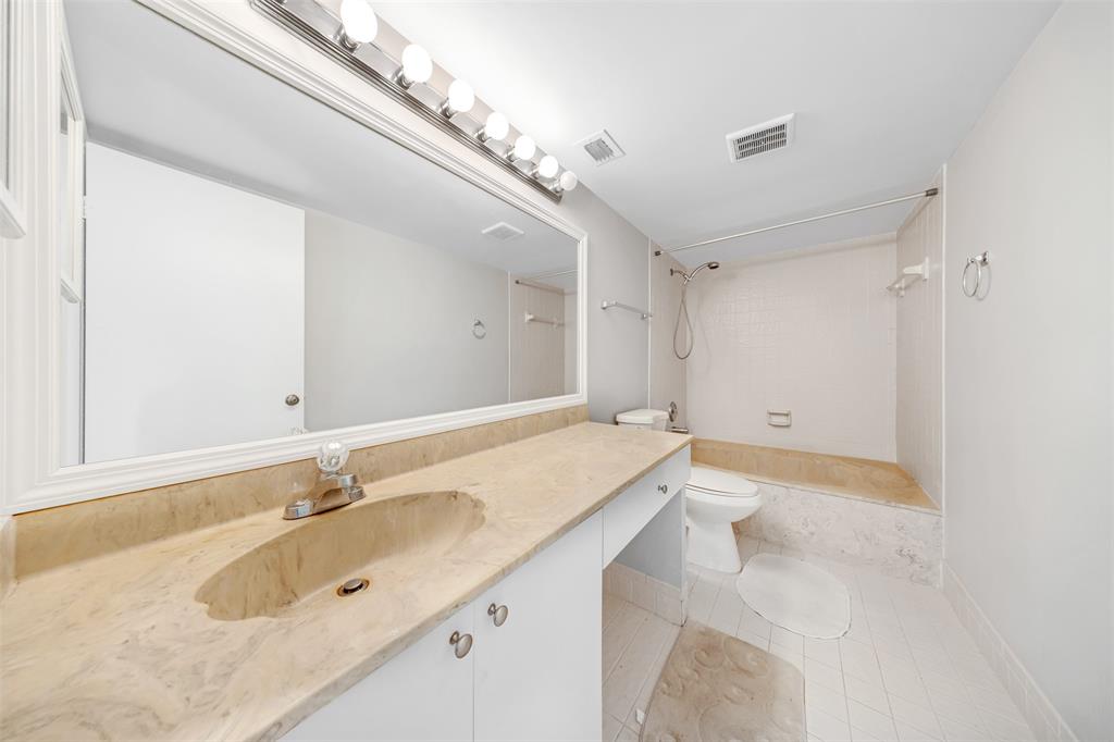 2202 South Cypress Bend Drive, Unit 207 Pompano Beach, FL 33069 - Photo 18 of 20 a bathroom with a sink double vanity and a bathtub