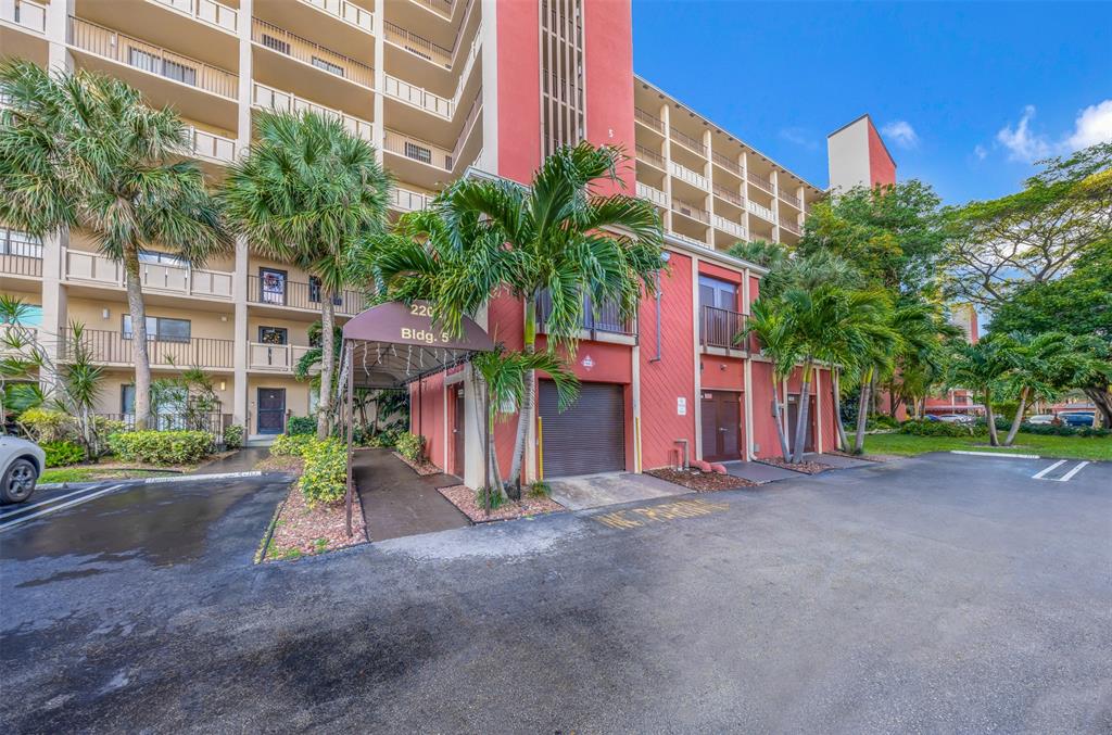 2202 South Cypress Bend Drive, Unit 207 Pompano Beach, FL 33069 - Photo 19 of 20 a view of a street with a building in front of it