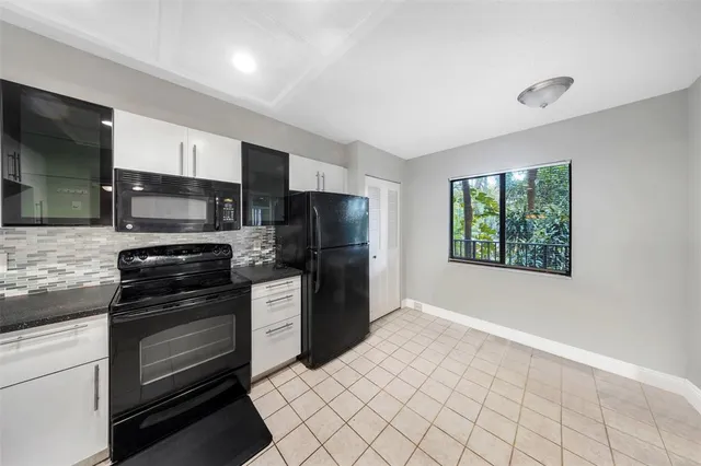 a kitchen with a refrigerator stove and microwave