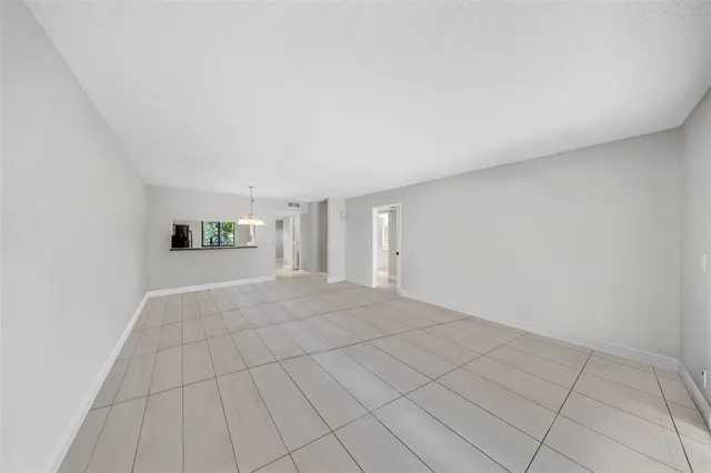 a view of a livingroom with an empty space and a window