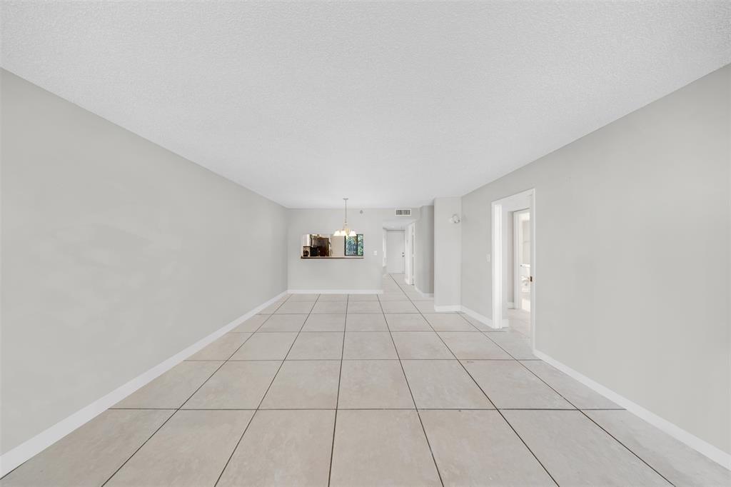 2202 South Cypress Bend Drive, Unit 207 Pompano Beach, FL 33069 - Photo 8 of 20 a view of an empty room with a window