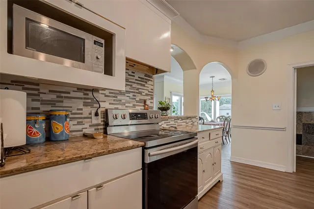 a kitchen with stainless steel appliances granite countertop a stove and a microwave