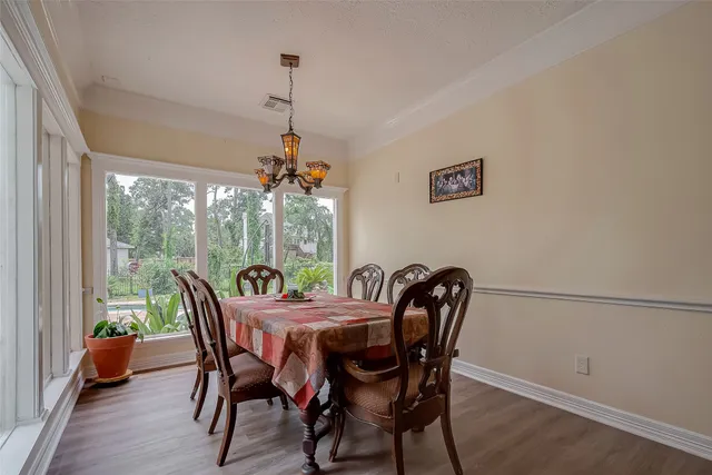 a bedroom with a bed a large window and furniture