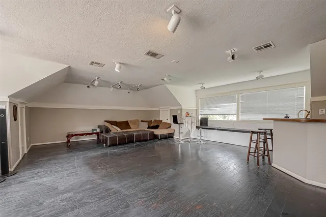 a view of a livingroom with furniture and a hallway