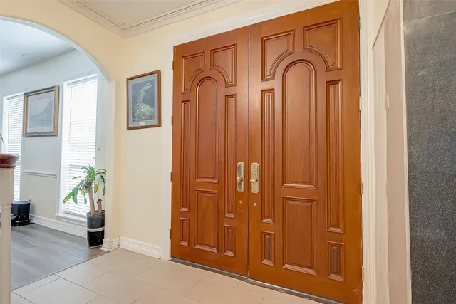 wooden floor with windows and potted plants