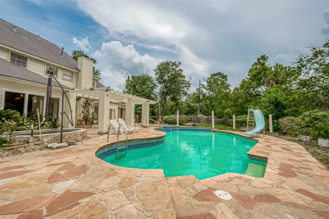 a view of a swimming pool with a patio