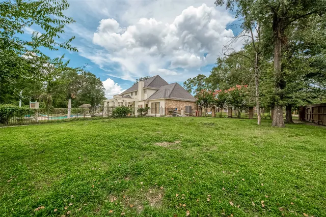 a view of a yard with a house and trees