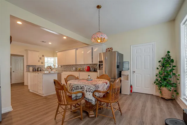 a dining room with furniture and wooden floor