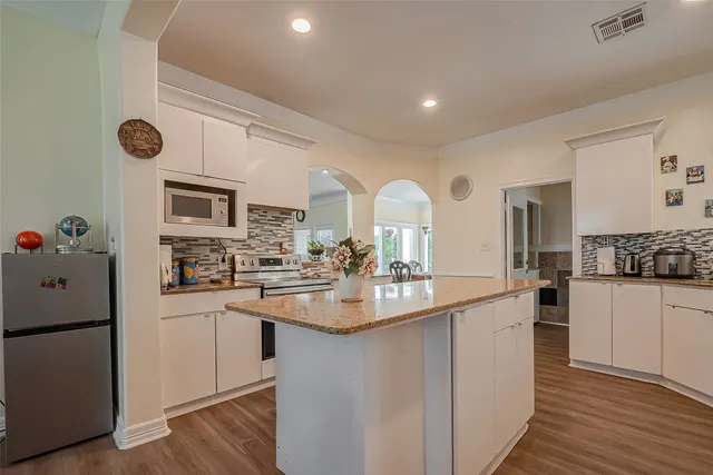 a kitchen with counter top space and cabinets