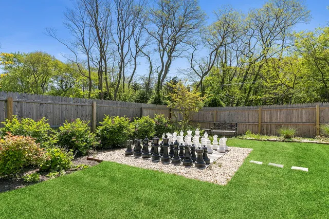 a view of a chair and table in the back yard