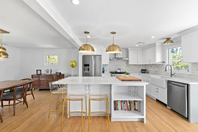 a large kitchen with a table and chairs in it