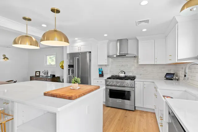 a kitchen that has a lot of cabinets and a refrigerator