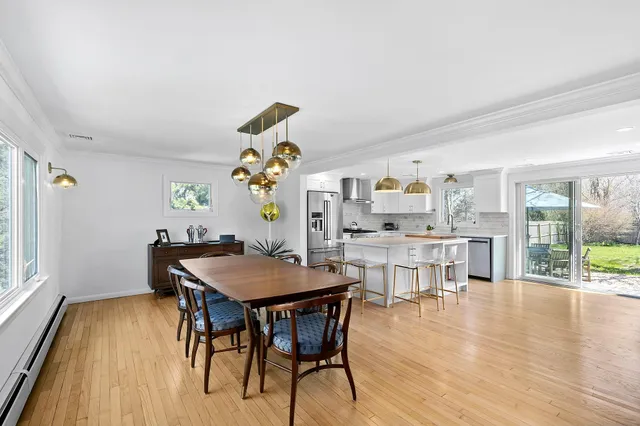 a view of a dining room with furniture and wooden floor