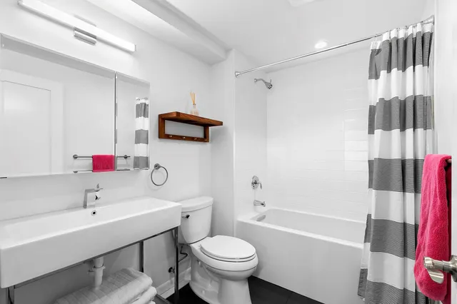 a bathroom with a sink toilet and shower