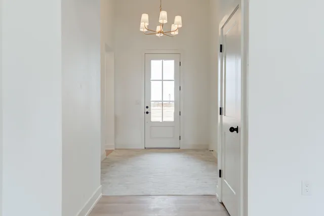 a kitchen with stainless steel appliances granite countertop a sink a stove a refrigerator and a oven