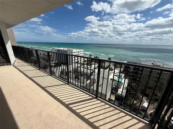 a view of balcony with wooden floor