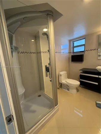 a bathroom with a toilet and a shower