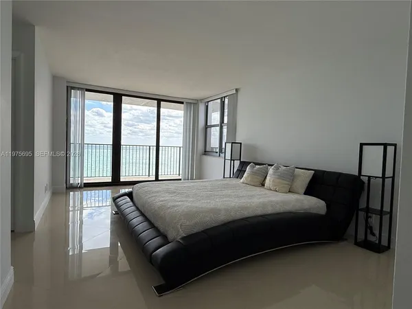 a bedroom with a bed and a large window