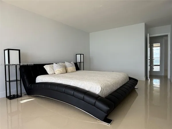 a bed sitting in a bedroom next to a window